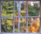 Fall colors through a window in Selectmen Building at Somesville Bridge in Maine. Art Print